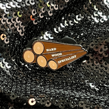 Load image into Gallery viewer, Enamel pin that features the phrase 'Hardwood Specialist' from Queen On The Scene.