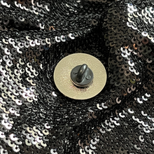 Load image into Gallery viewer, Backside of the he/they pronoun pin from Queen On The Scene. One secure fastener.