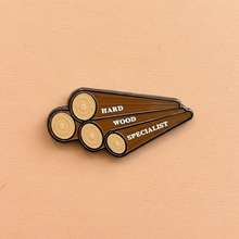 Load image into Gallery viewer, Enamel pin that features the phrase 'Hardwood Specialist' from Queen On The Scene.