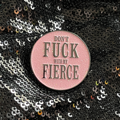 Round pink glitter enamel pin from Queen On The Scene. 