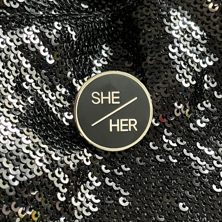 She/her pronoun pin from Queen On The Scene.