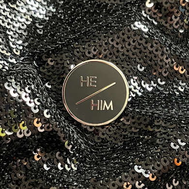 He/him pronoun pin that's round, sleek and professional from Queen On The Scene.