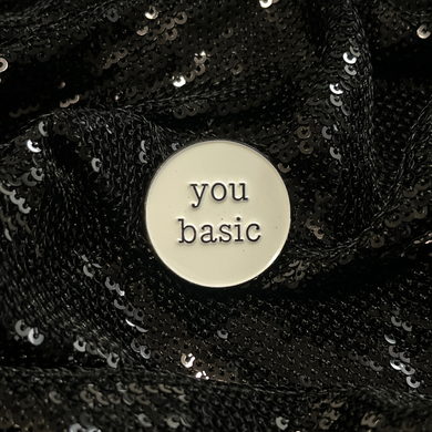 'You Basic' Snarky Enamel Pin from Queen On The Scene. Round enamel pin with the words 'You Basic' on it with typeface style text.